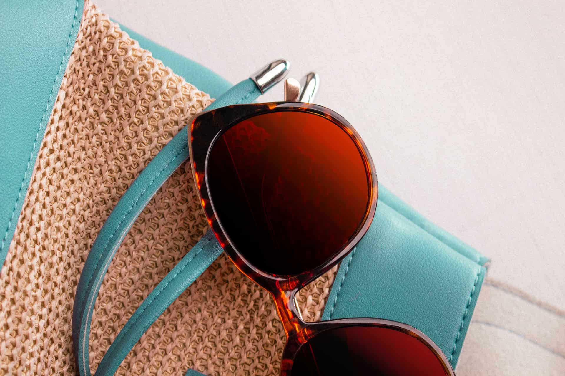 A glossy tortoiseshell acetate sunglasses frame photographed close up in warm light