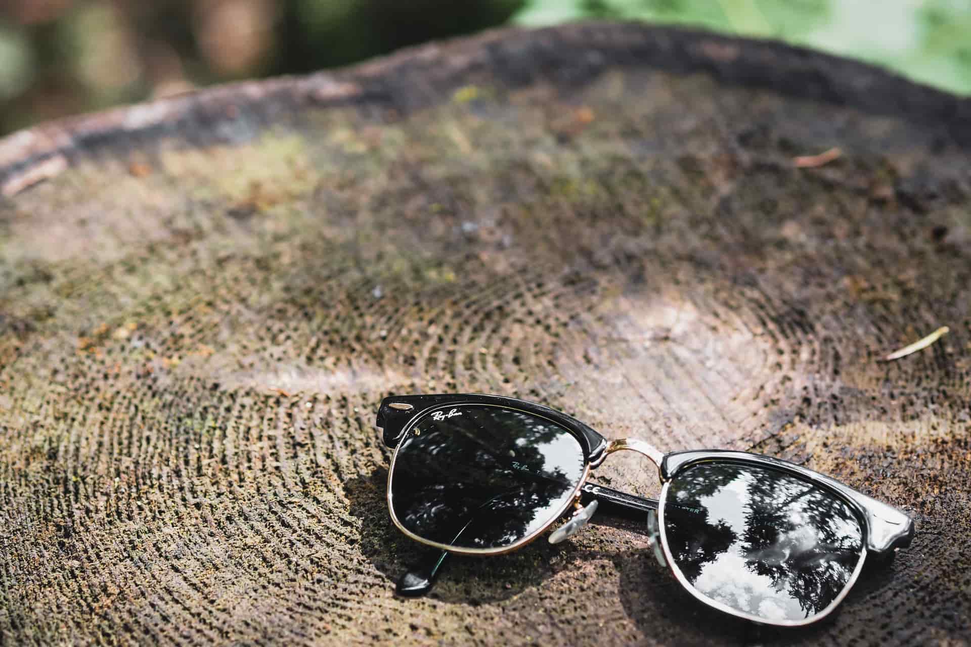 Classic wayfarer-style acetate sunglasses on a wooden surface
